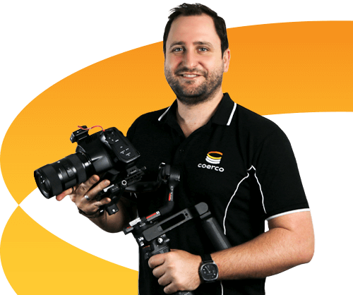 Coerco videographer holding camera